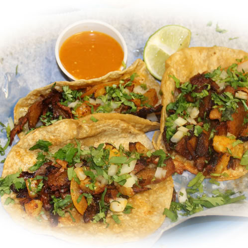 Delicious tacos served in a traditional Mexican platter with vibrant decor, ready to enjoy.